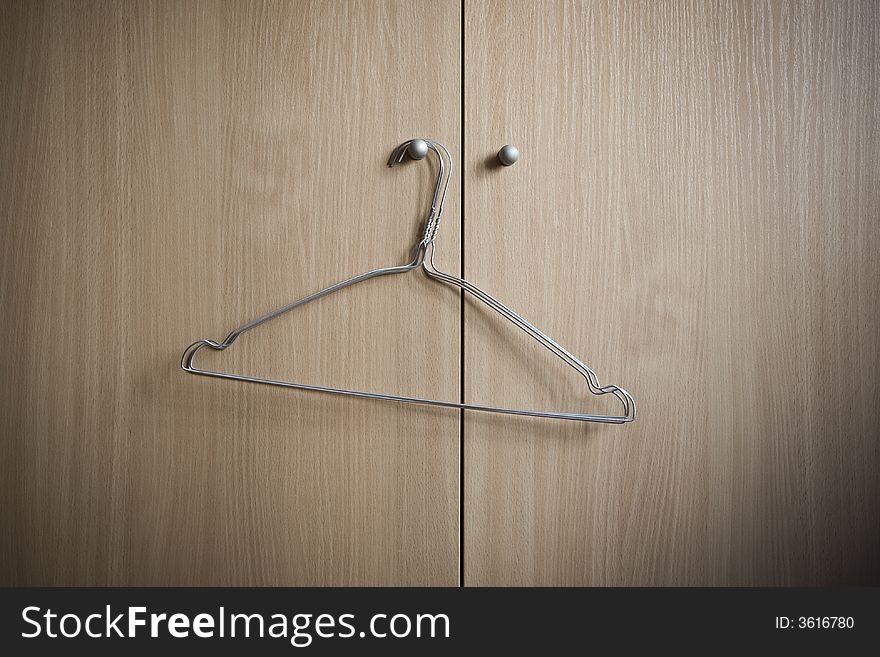 Metal hangers on the handle of a wardrobe