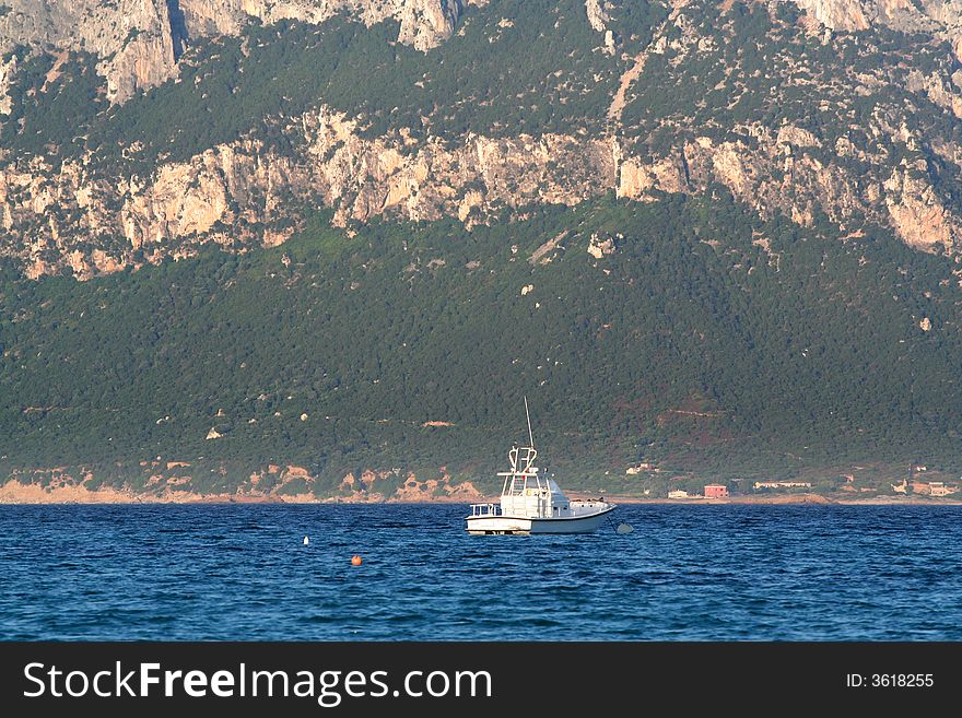 Yacht with Tavolara Island (sardinia) in the background. Yacht with Tavolara Island (sardinia) in the background