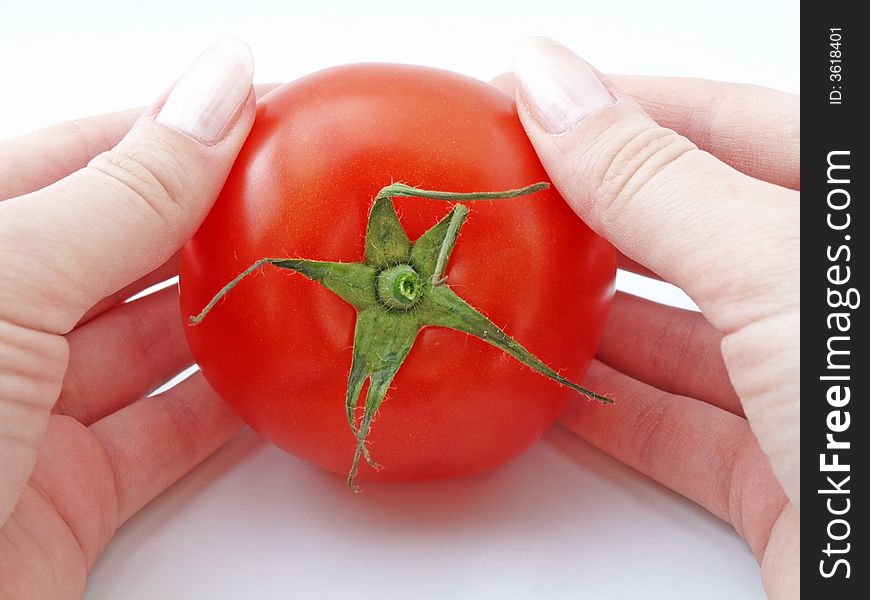 Fresh tomato in womans hands