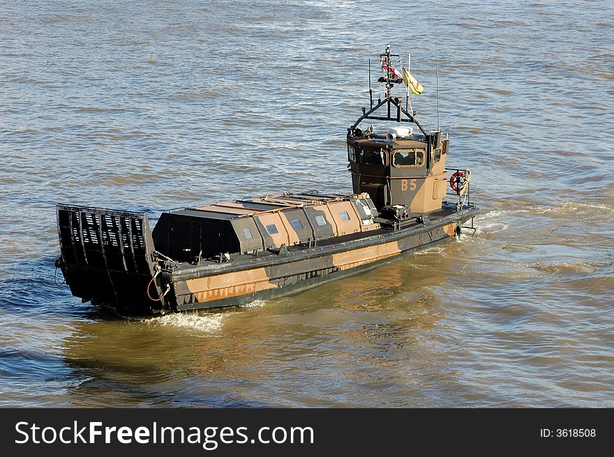 Small navy boat in The Thames river