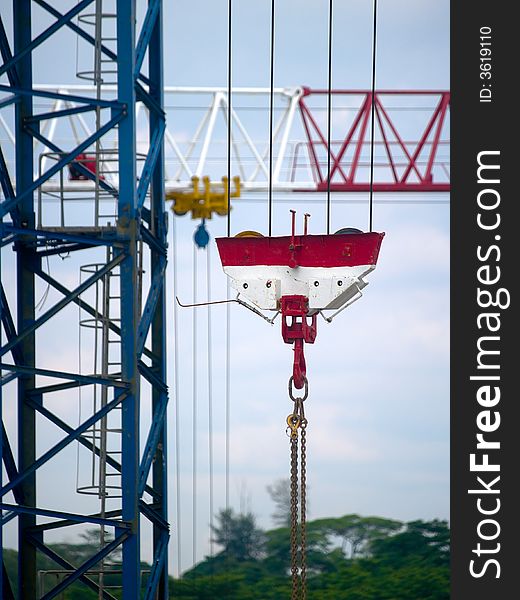 Pulley blocks of tower cranes at work in a construction site. Pulley blocks of tower cranes at work in a construction site