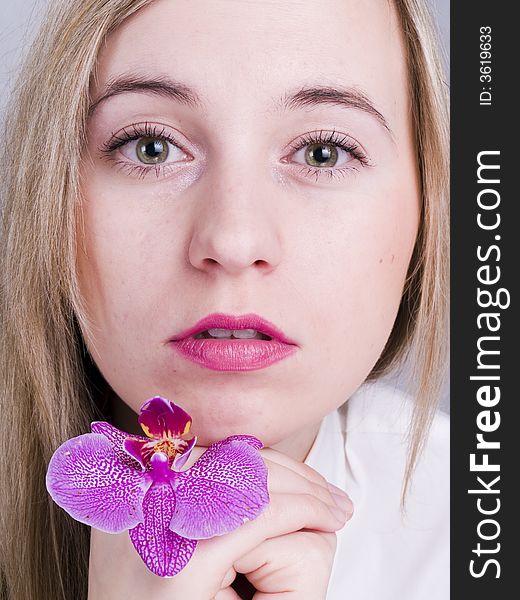 Portrait of bonde woman with orchid. Portrait of bonde woman with orchid