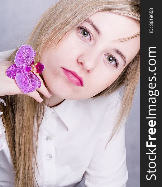 Portrait of blonde woman with pink orchid. Portrait of blonde woman with pink orchid
