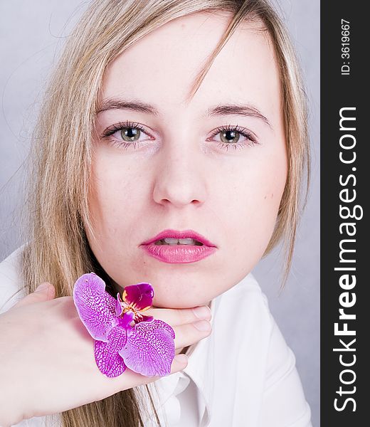 Portrait of blonde woman with pink orchid. Portrait of blonde woman with pink orchid