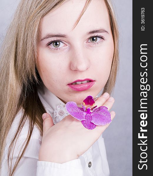 Portrait of beautiful woman with pink orchid. Portrait of beautiful woman with pink orchid