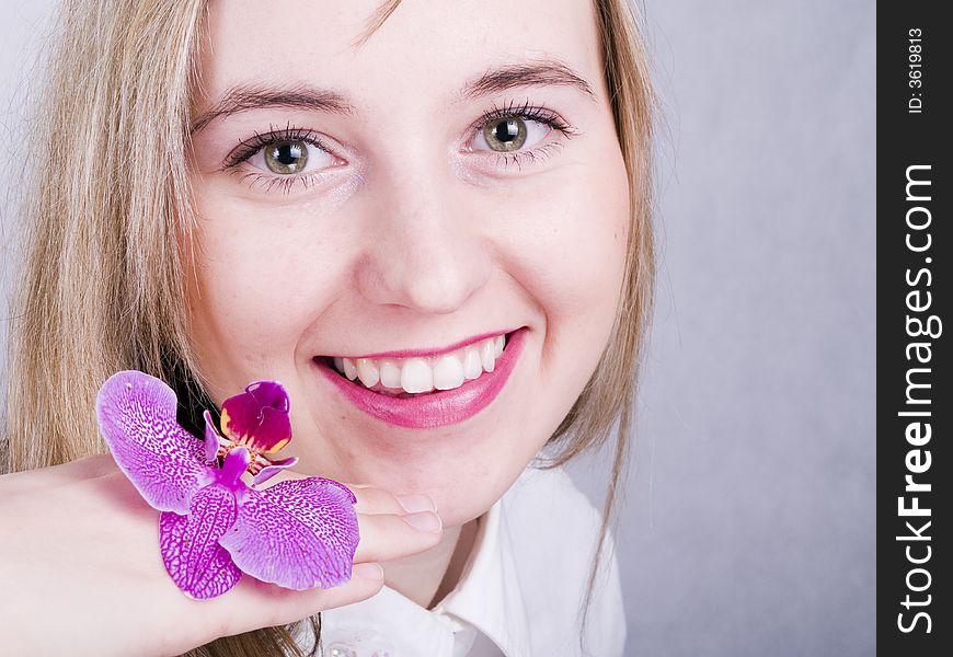 Smiling young woman with flower. Smiling young woman with flower