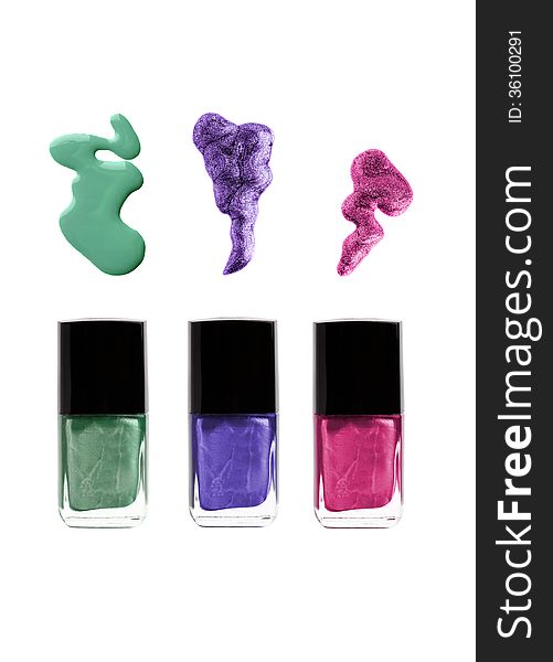 Nail polish bottles with spills: green, violet, purple or pink colors