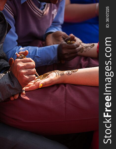 Indian bride getting henna mehndi designs on her hand for the wedding. Indian bride getting henna mehndi designs on her hand for the wedding