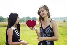 Two Pretty Women In Love With Red Heart In Sunshine Summer Field Royalty Free Stock Images Two Pretty Women In Love With Red Heart In Sunshine Summer Field Royalty Free Stock Images