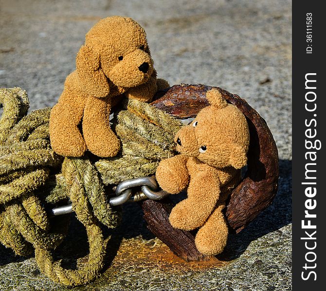 Stuffed toys playing around rusty chains and ropes at Mousehole harbour. Stuffed toys playing around rusty chains and ropes at Mousehole harbour.