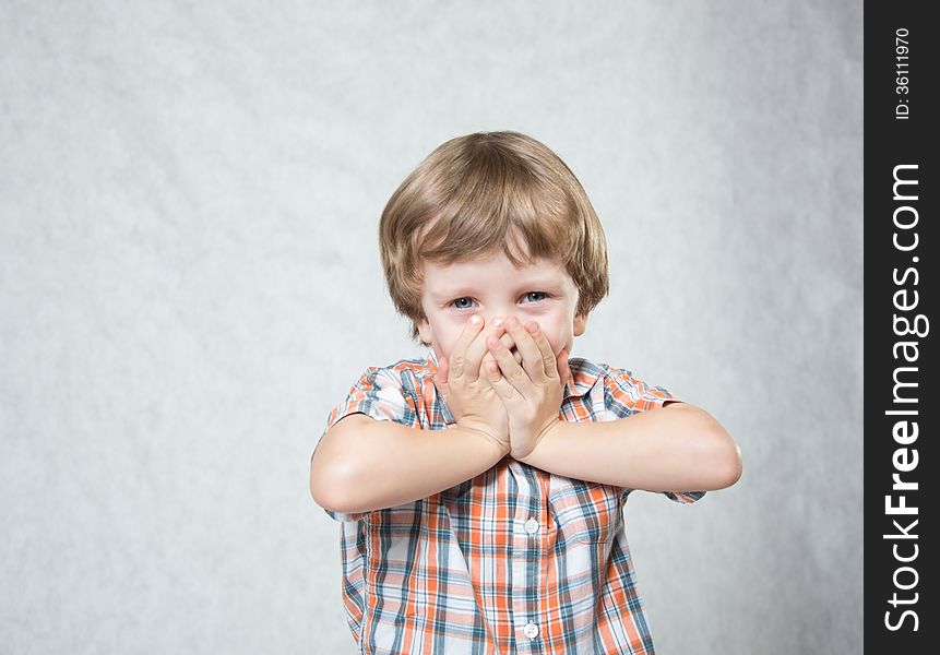 Blond boy shows both hands okay and laughs. Blond boy shows both hands okay and laughs