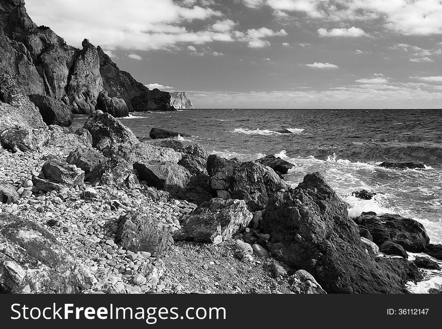 Ukraine, peninsula of Crimea, Sea coast on the Black Sea, large and small pebbles, large boulders, sea waves. Ukraine, peninsula of Crimea, Sea coast on the Black Sea, large and small pebbles, large boulders, sea waves