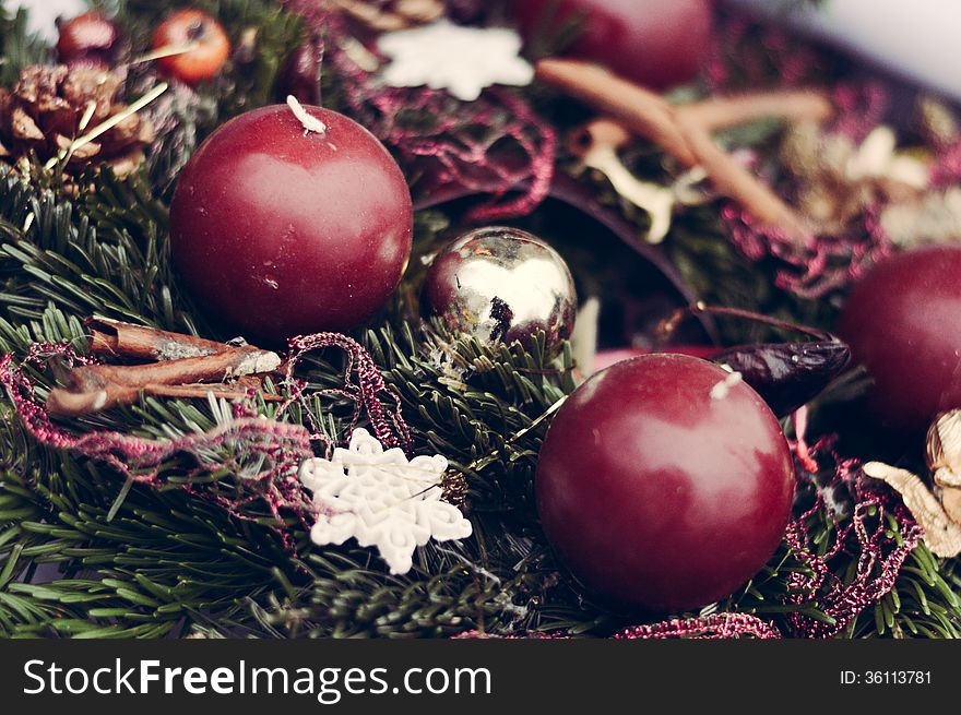 Closeup On Christmas Candles On Pine Garland Decoration