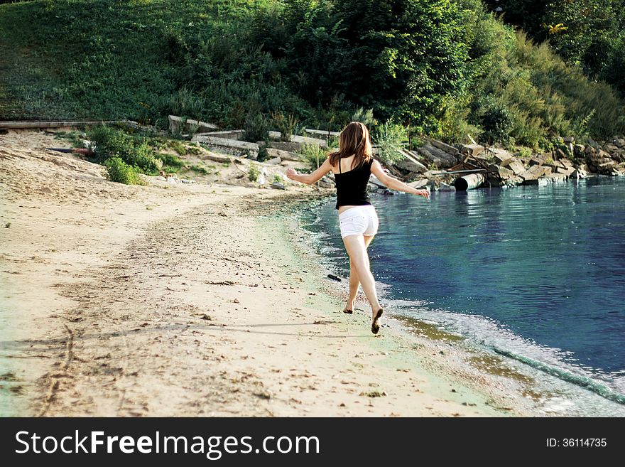 Happy woman jumping trough the beach. Happy woman jumping trough the beach