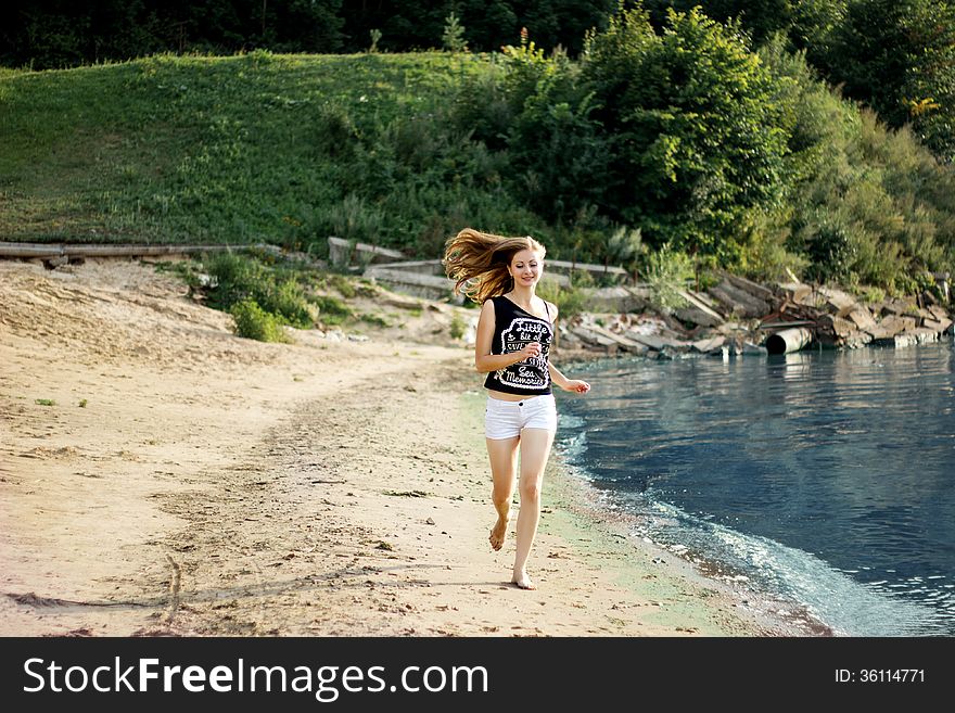 Happy woman jumping trough the beach. Happy woman jumping trough the beach