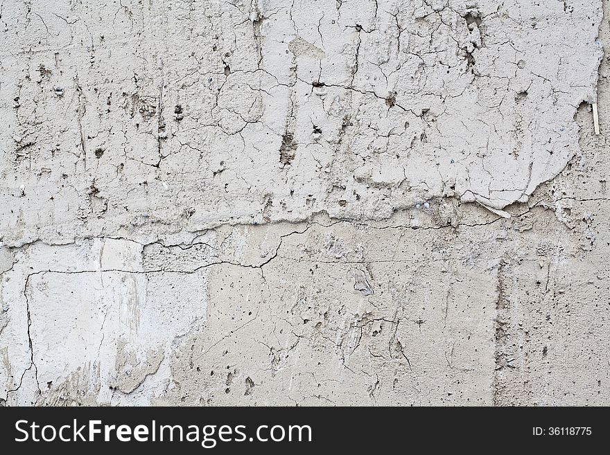 Closeup view of a light plaster.Texture with cracks. Closeup view of a light plaster.Texture with cracks.