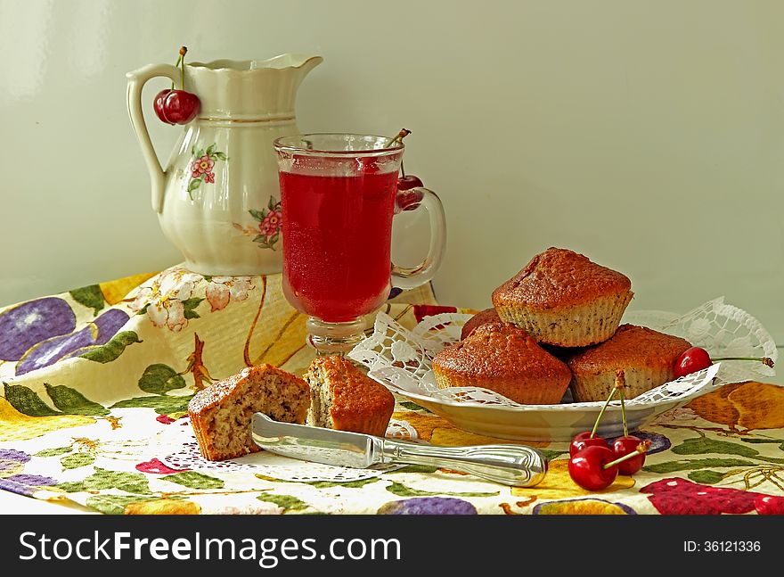 Baked homemade muffins, cherry and cold drink. Baked homemade muffins, cherry and cold drink