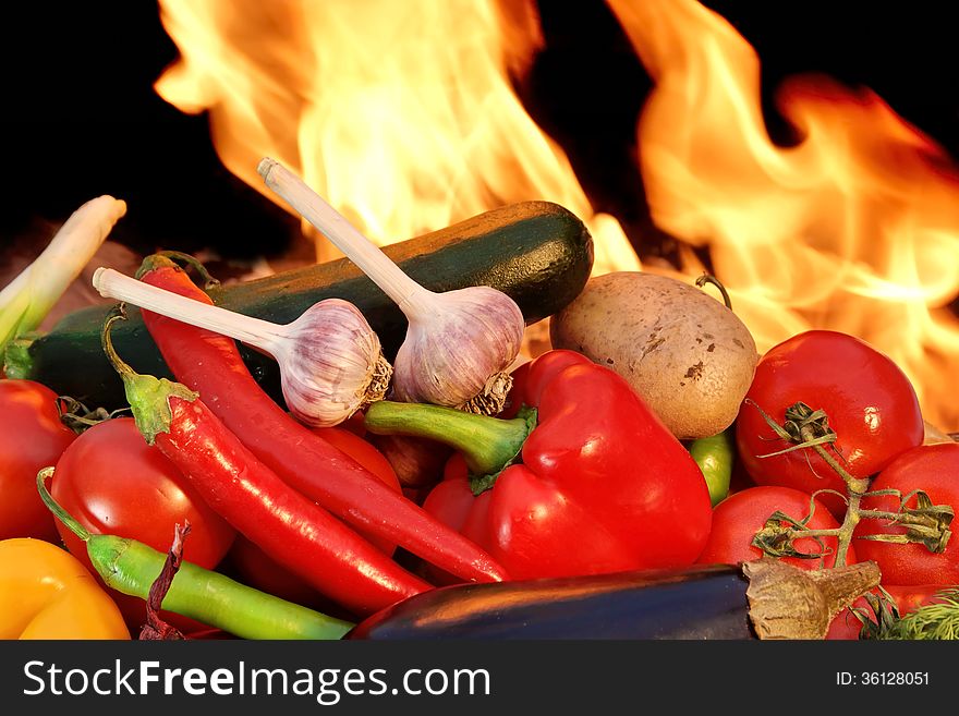 Assorted fresh vegetables in a pile before the flame from BBQ facilities. Assorted fresh vegetables in a pile before the flame from BBQ facilities