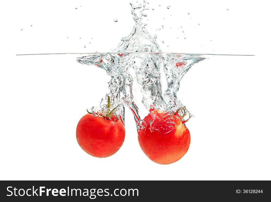Fresh tomatoes falling into the water. Fresh tomatoes falling into the water