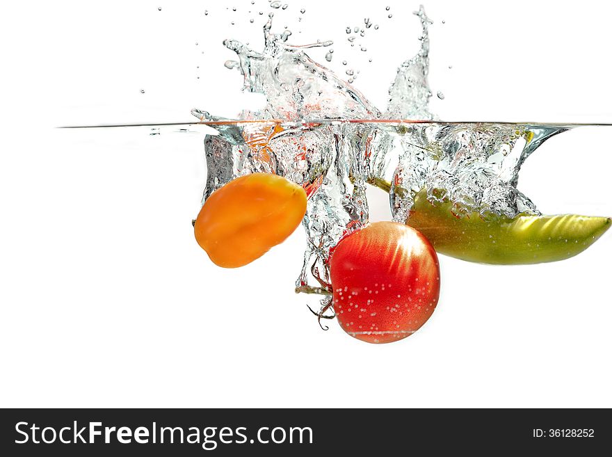 Fresh tomatoes falling into the water. Fresh tomatoes falling into the water