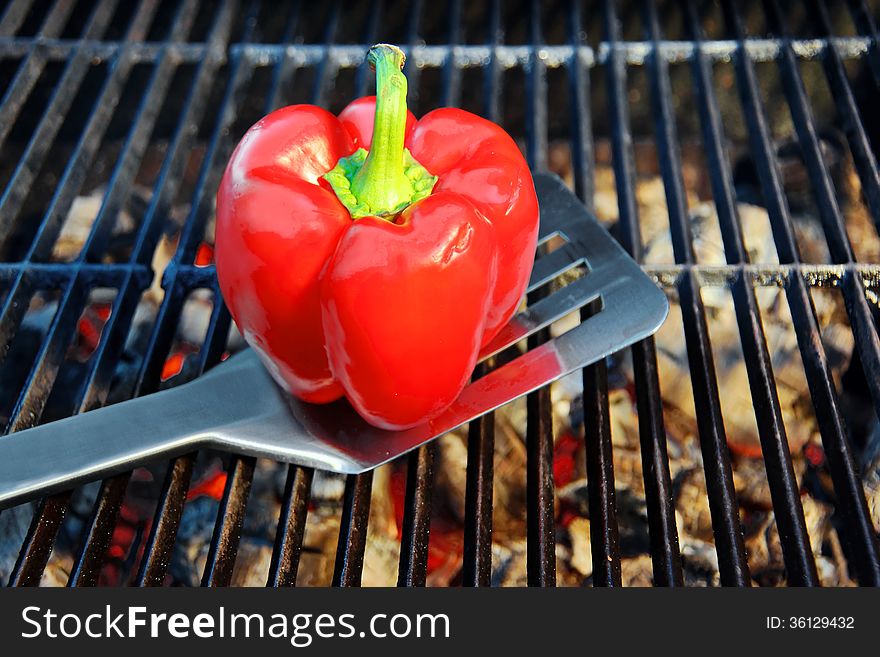 Spatula and Bell Pepper on the hot BBQ cast iron grill