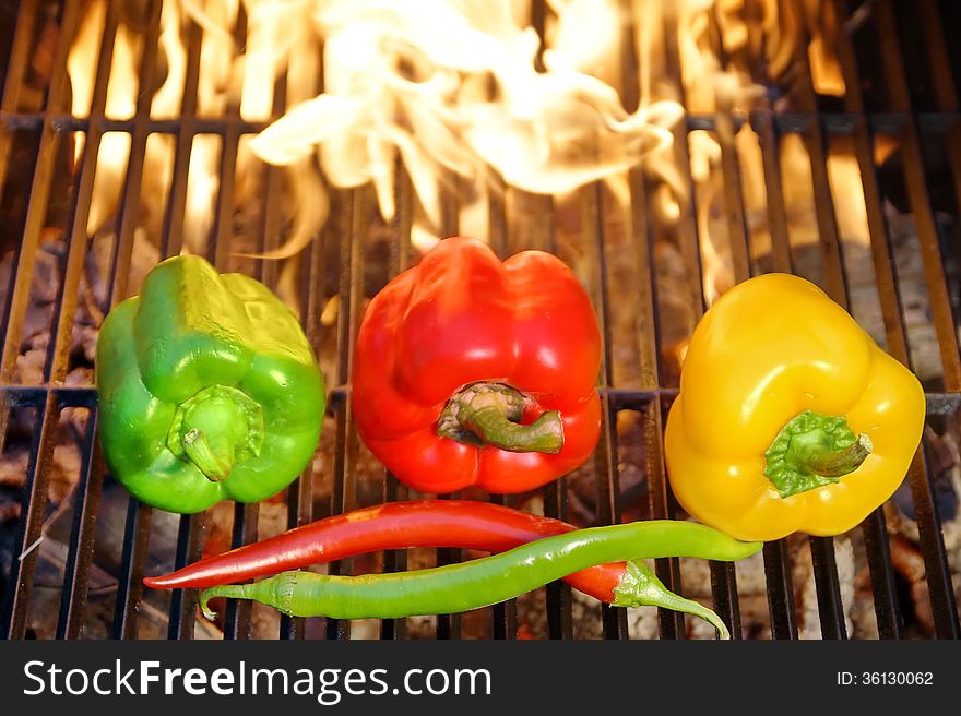 Colorful Bell and Chile peppers on the BBQ cast iron Grill