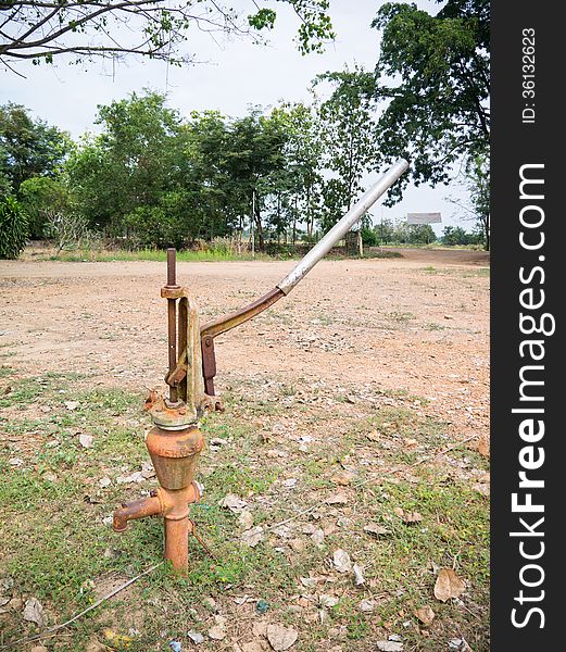 Old rusty iron water hand pump. Old rusty iron water hand pump