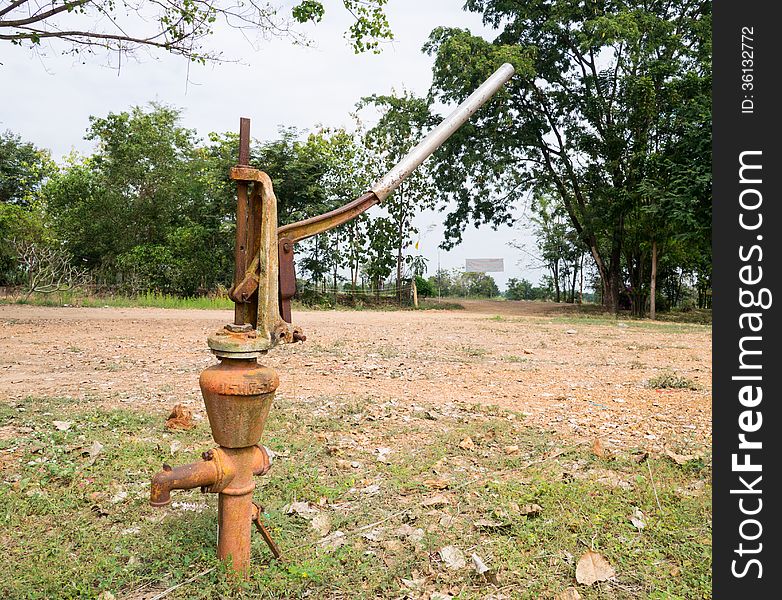 Old rusty iron water hand pump. Old rusty iron water hand pump