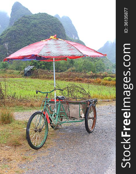 Alternative transport by retro carrier cycle taxi with parasol, Yangshuo, China