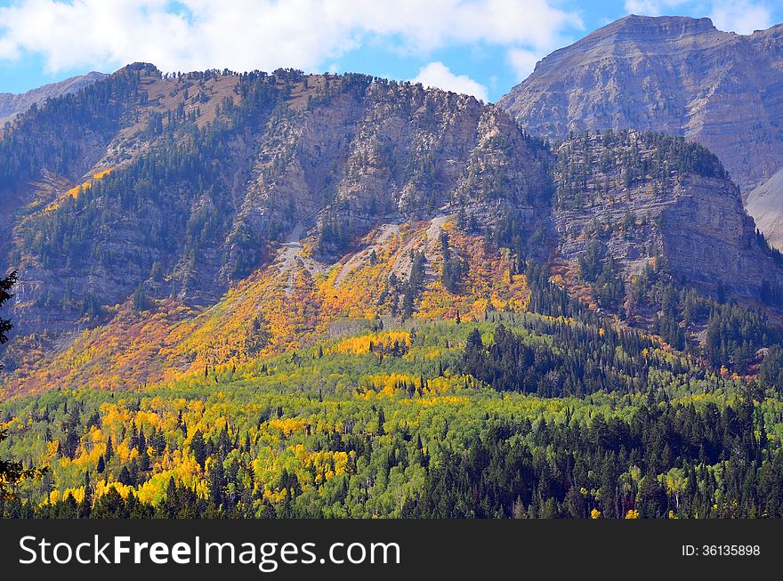 Fall colors climb rugged cliffs in a mountain scene near Provo, Utah. Fall colors climb rugged cliffs in a mountain scene near Provo, Utah.