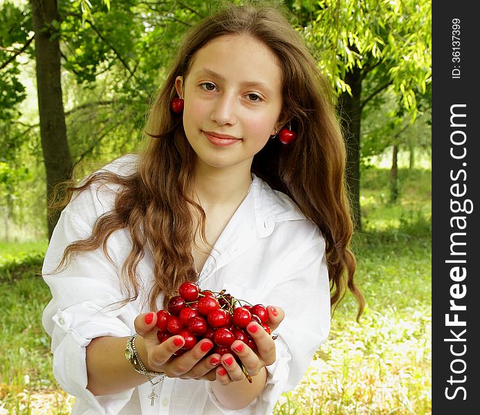 Girl with her hair holding a handful of ripe cherries. Girl with her hair holding a handful of ripe cherries