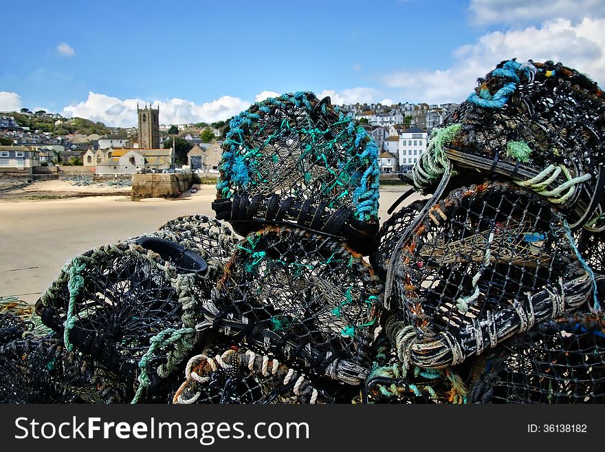 Lobster pots stacked up on the wharf at St Ives, Cornwall. Lobster pots stacked up on the wharf at St Ives, Cornwall