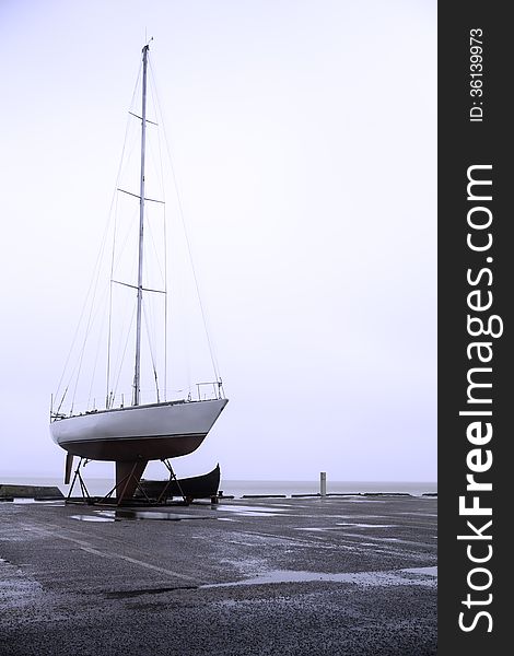 Sailboat in a harbor during autumn and winter