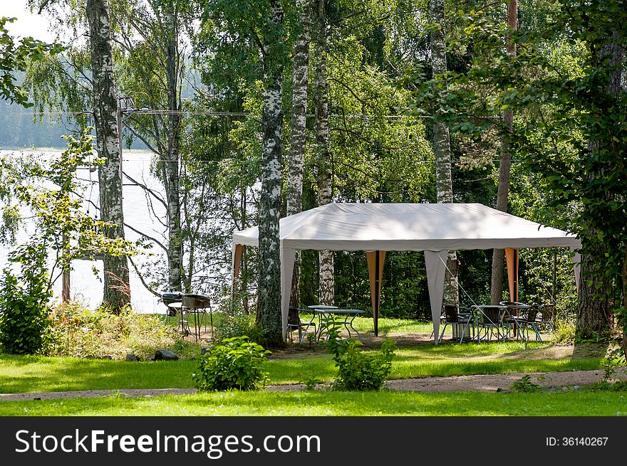 Resting place for barbecue in the forest on the shore of lake