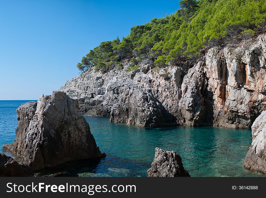 Rocky bay with green mediterranean vegetation