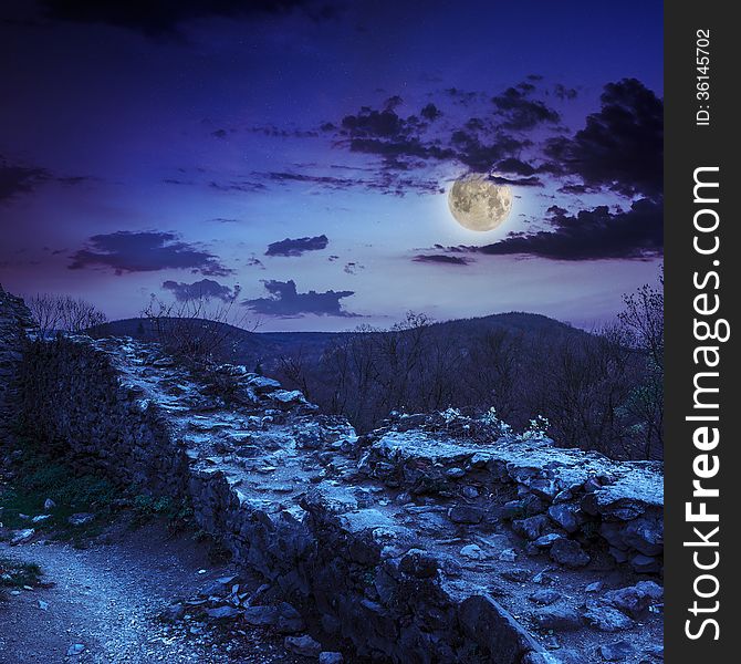 Ruins of an old castle in the mountains at night