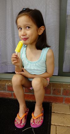 Young Asian Girl Eating An Icy-pole. Stock Images