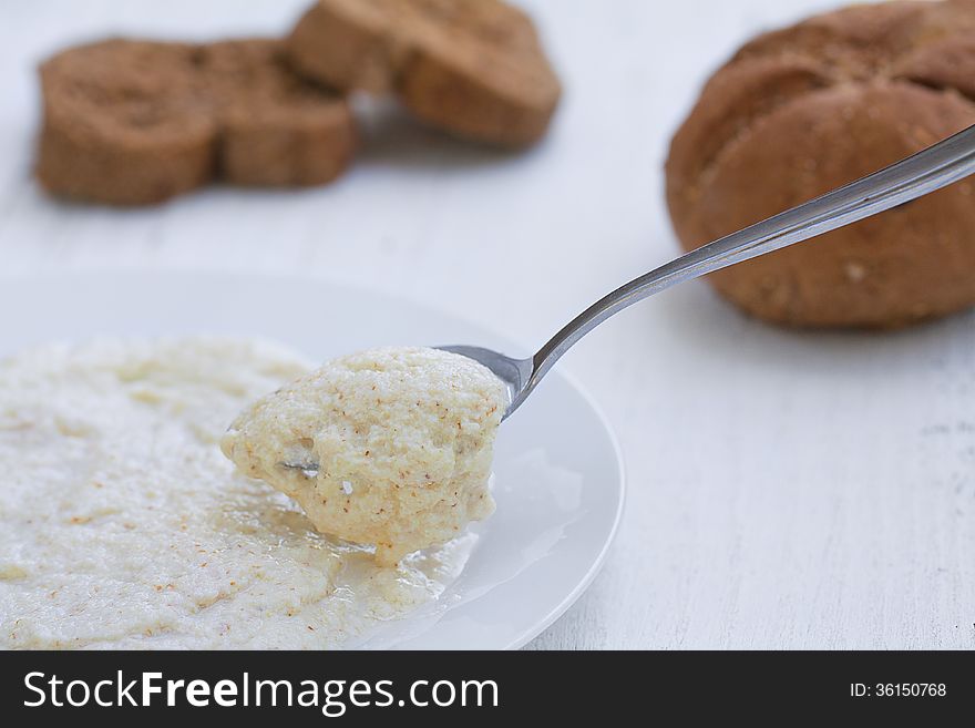 Porridge oats with spoon and bread, healthy breakfast