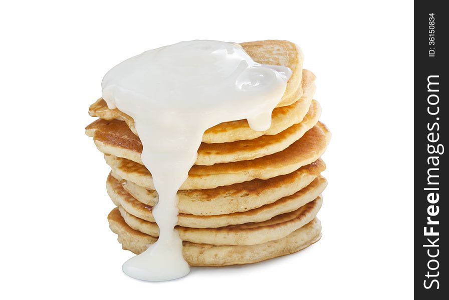 A stack of pancakes with sour cream. Isolated on white. A stack of pancakes with sour cream. Isolated on white.