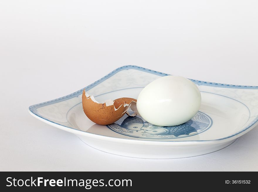 An peeled egg in a plate. An peeled egg in a plate.