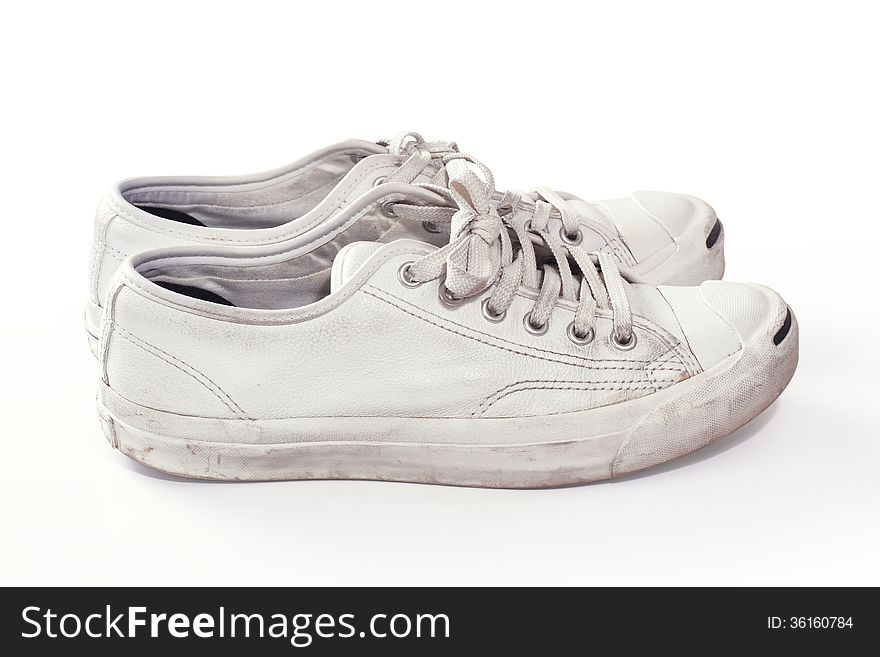 Pair of used sneakers in white background. Pair of used sneakers in white background