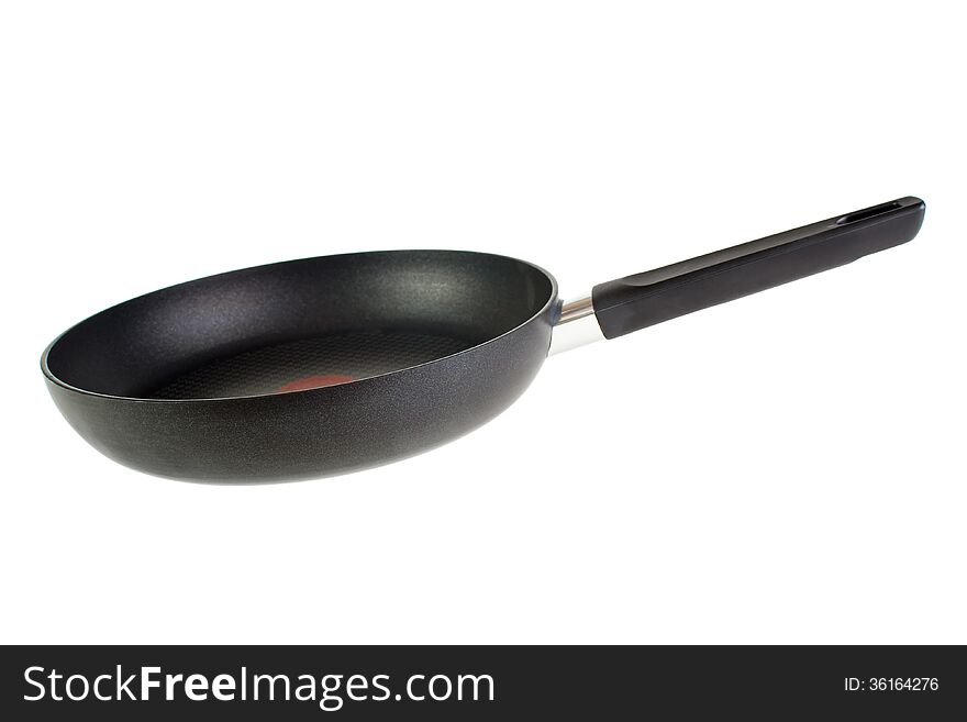 Black teflon coated frying pan , isolated on white