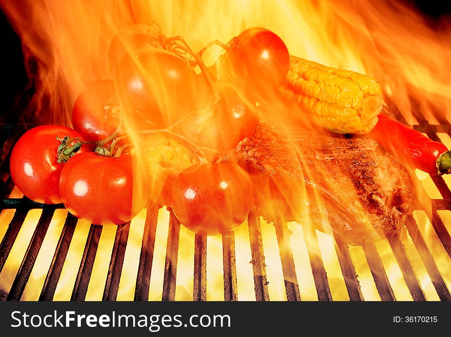 Grilled Rib Steak And Vegetables In The Flames Of  BBQ