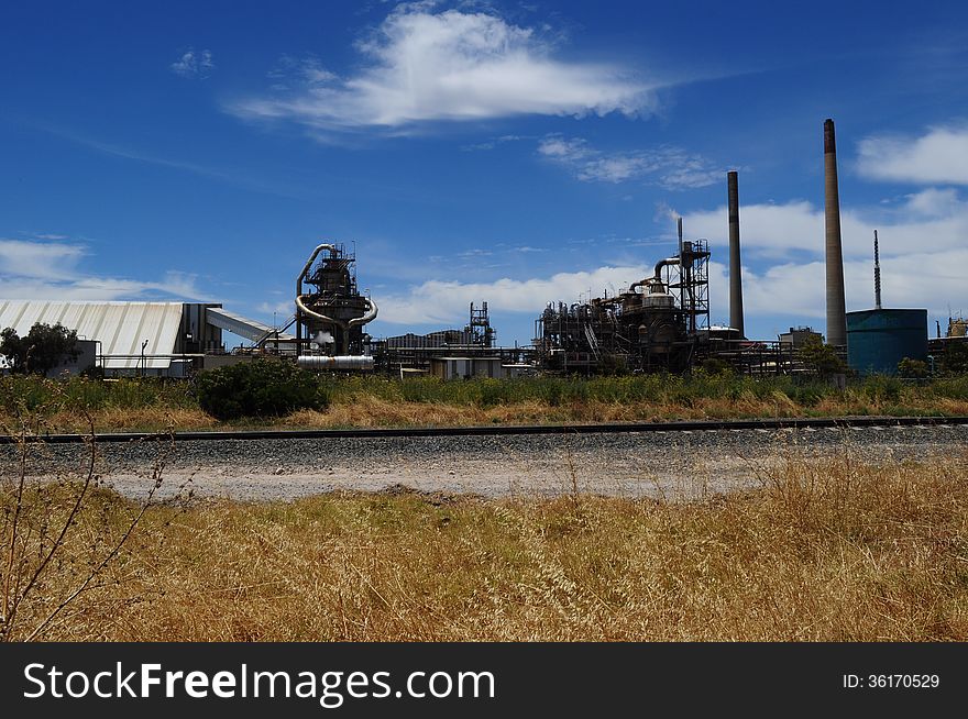 Refinery and train tracks in bush environment. Refinery and train tracks in bush environment