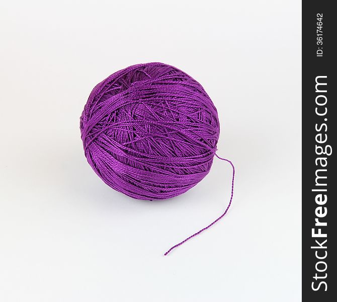 A tangle purple thread for knitting on a light background. A tangle purple thread for knitting on a light background