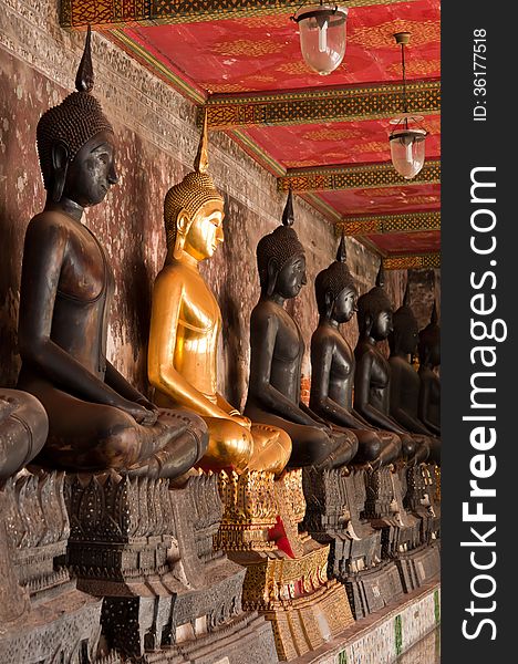 The Sitting Golden Buddha Stute And Black Stute In Ancient Temple Of Thailand