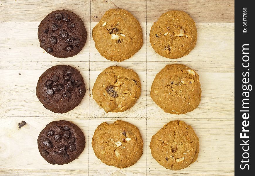 Rim line pattern of xo game, play by brown and dark brown cookies on wood background. Rim line pattern of xo game, play by brown and dark brown cookies on wood background.