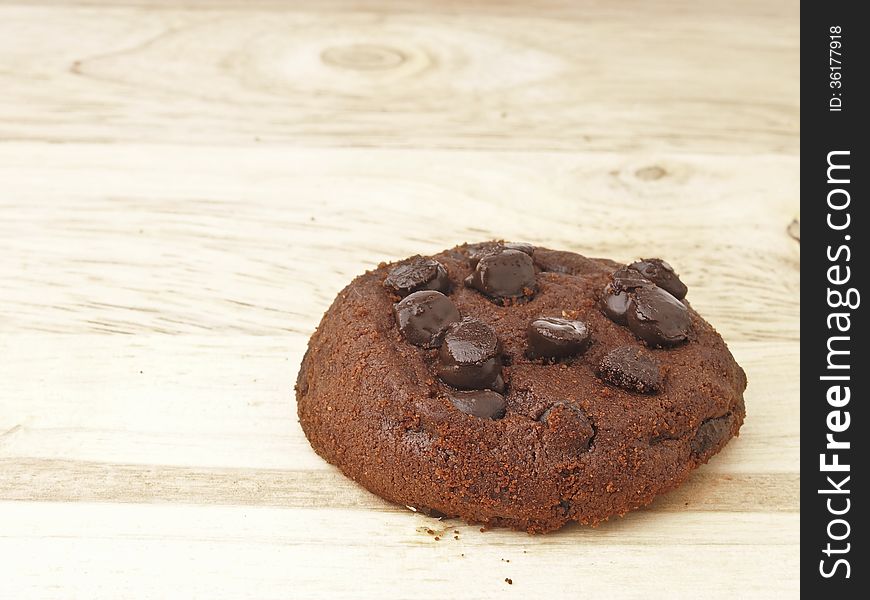 Delicious chocolate chip cookies on wood background