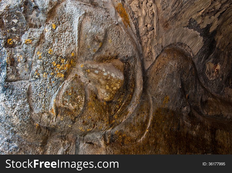 The Stucco Of Ancient Reclining Buddha At The Khao Ngu Cave In T