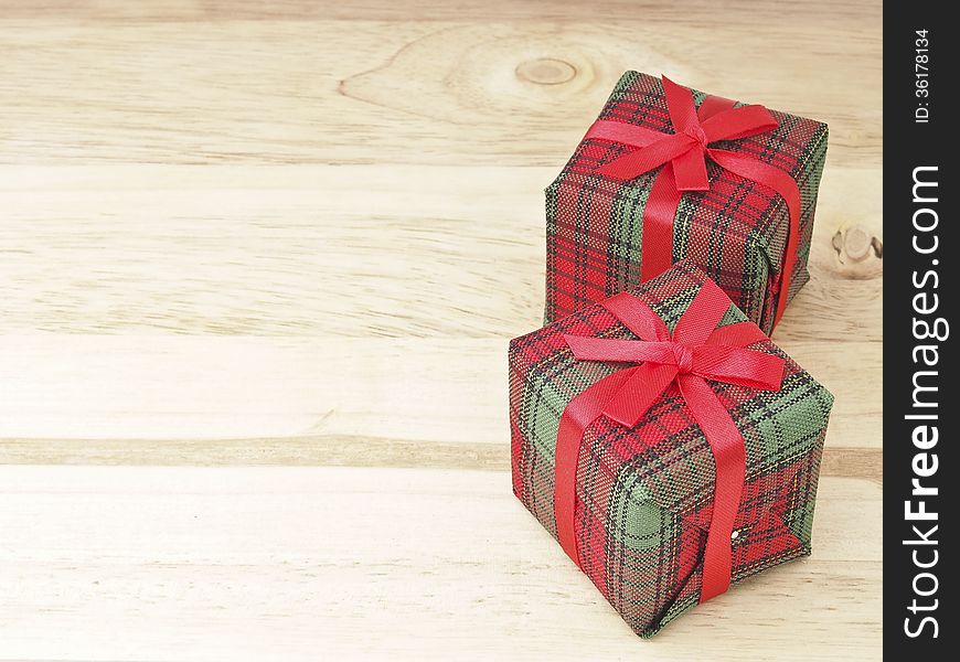 Pair of red gift box decorate on wood background. Pair of red gift box decorate on wood background